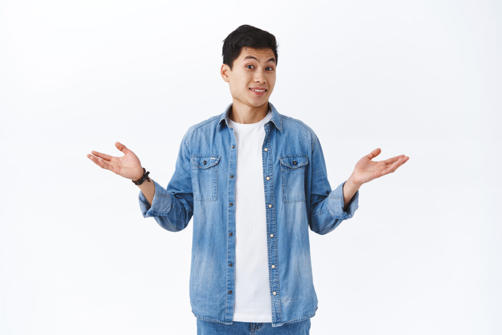 Portrait of clueless handsome asian young man cant answer, have